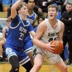 KEITH THORPE/PENINSULA DAILY NEWS
Port Angeles' Isaiah Shamp, right, waits for his moment at the hoop as Olympic's Ryder Wright defends the lane on Tuesday at Port Angeles High School.