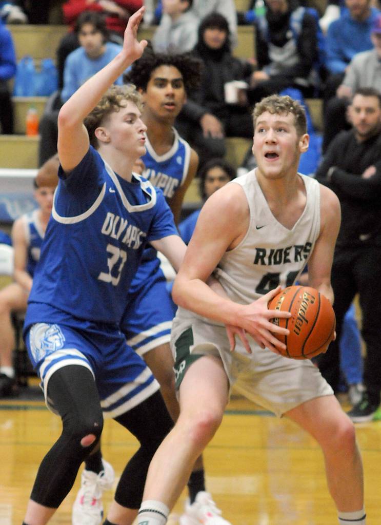 KEITH THORPE/PENINSULA DAILY NEWS
Port Angeles' Isaiah Shamp, right, waits for his moment at the hoop as Olympic's Ryder Wright defends the lane on Tuesday at Port Angeles High School.