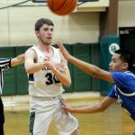 KEITH THORPE/PENINSULA DAILY NEWS
Port Angeles' Bryant Hoch, left, passes around Olympic's Sean Clegg on Tuesday in Port Angeles.