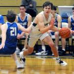 Port Angeles Parker Nickerson, right, dribbles past Olympics Jackson Barrett on Tuesday night in Port Angeles. (Keith Thorpe/Peninsula Daily News)
