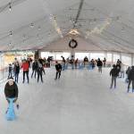 Skaters make their way around the rink at the Port Angeles Winter Ice Village on Thursday, assembled seasonally in a city parking lot in the 100 block of West Front Street. The same site is slated for a roller rink  next summer. (Keith Thorpe/Peninsula Daily News)