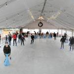 Skaters make their way around the rink at the Port Angeles Winter Ice Village on Thursday, assembled seasonally in a city parking lot in the 100 block of West Front Street. The same site is slated for a roller rink  next summer. (Keith Thorpe/Peninsula Daily News)