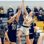 Forks Kadie Wood scores over Ilwacos Olivia McKinstry during the Spartans 75-64 win over Ilwaco at home Wednesday. (Lonnie Archibald/for Peninsula Daily News)
