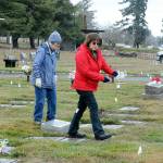 Jan Urfer, left, and Anita Reynolds scout out headstones on Thursday that will receive a wreath for Saturdays Wreaths Across America ceremony at Mount Angeles Memorial Park in Port Angeles. The women, members of the Michael Trebert Chapter of the Daughters of the American Revolution, were helping prepare for the event, which honors veterans for their service. Around 2,700 sponsored wreaths are planned for placement at Blue Mountain, Dungeness, Gardiner, Sequim View, Mount Angeles and Forks cemeteries, with a formal service planned for 11 a.m. Saturday at Mount Angeles. (Keith Thorpe/Peninsula Daily News)