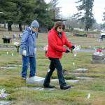 Jan Urfer, left, and Anita Reynolds scout out headstones on Thursday that will receive a wreath for Saturdays Wreaths Across America ceremony at Mount Angeles Memorial Park in Port Angeles. The women, members of the Michael Trebert Chapter of the Daughters of the American Revolution, were helping prepare for the event, which honors veterans for their service. Around 2,700 sponsored wreaths are planned for placement at Blue Mountain, Dungeness, Gardiner, Sequim View, Mount Angeles and Forks cemeteries, with a formal service planned for 11 a.m. Saturday at Mount Angeles. (Keith Thorpe/Peninsula Daily News)
