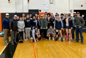 The Forks boys wrestling team celebrates its first-place trophy at the Rainier Duals Tournament this weekend. (Forks wrestling)