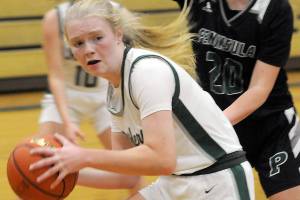 KEITH THORPE/PENINSULA DAILY NEWS
Port Angeles's Paige Mason, front, looks for an out as Peninsula's Ashley Edmonds closes in during Saturday's game at Port Angeles High School.