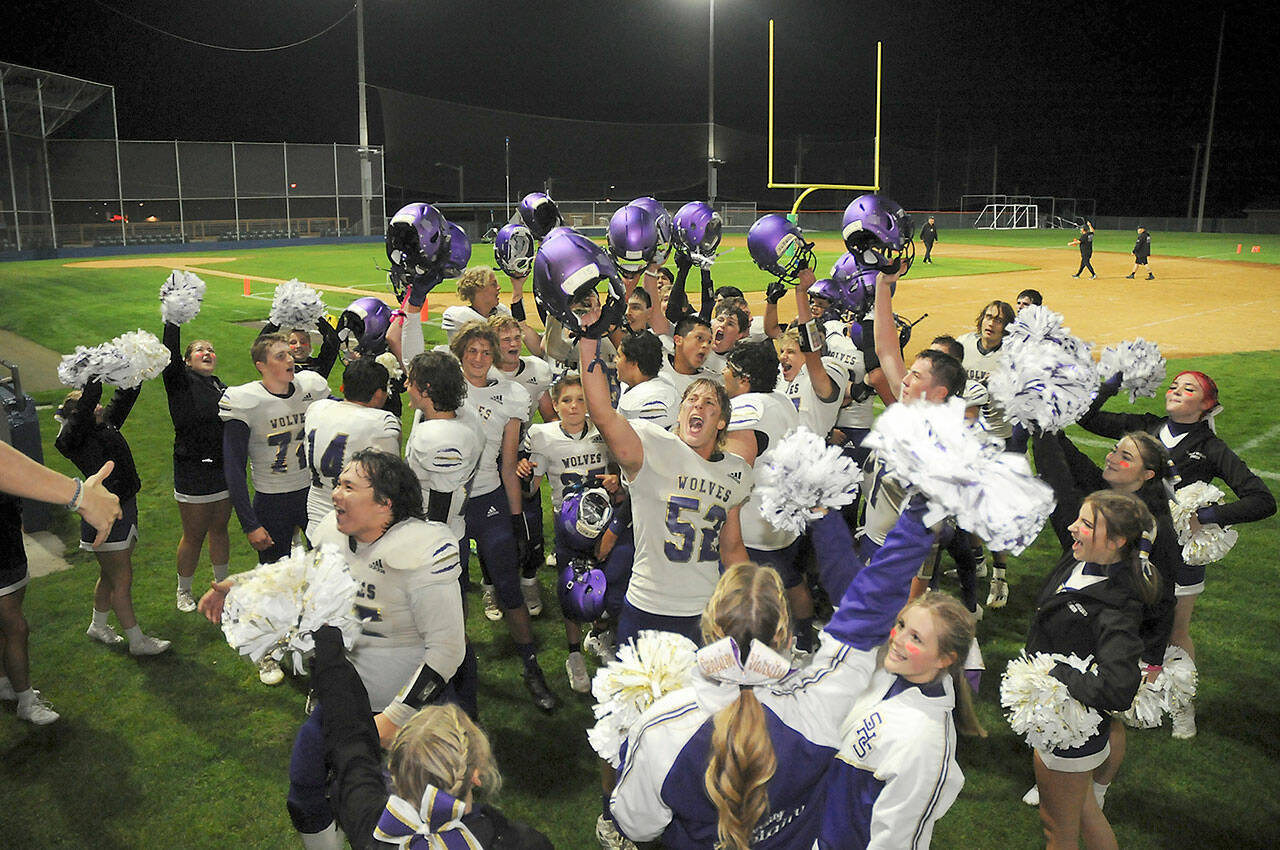 Members of the Sequim Wolves football team and cheer squad celebrate Friday nights 36-32 come-from-behind victory over the Port Angeles Roughriders at Port Angeles Civic Field. (Keith Thorpe/Peninsula Daily News)