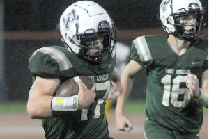 KEITH THORPE/PENINSULA DAILY NEWS
Port Angeles' Jason Hawes, left, takes a punt return from deep in Roughrider territory for a second quarter touchdown against Kingston as teammate Blake Sohlberg follows behind on Friday at Port Angeles Civic Field.