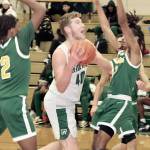Port Angeles Isaiah Shamp drives hard to the basket between the hands of Foss defenders last week. (Dave Logan/for Peninsula Daily News)
