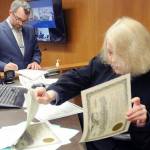 Newly elected Clallam County Commissioner Mike French, left, signs documents as Clallam County Superior Court Judge Lauren Erickson sorts election certificates during a swearing-in ceremony on Wednesday at the Clallam County Courthouse in Port Angeles. (Keith Thorpe/Peninsula Daily News)