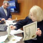 Newly elected Clallam County Commissioner Mike French, left, signs documents as Clallam County Superior Court Judge Lauren Erickson sorts election certificates during a swearing-in ceremony on Wednesday at the Clallam County Courthouse in Port Angeles. (Keith Thorpe/Peninsula Daily News)