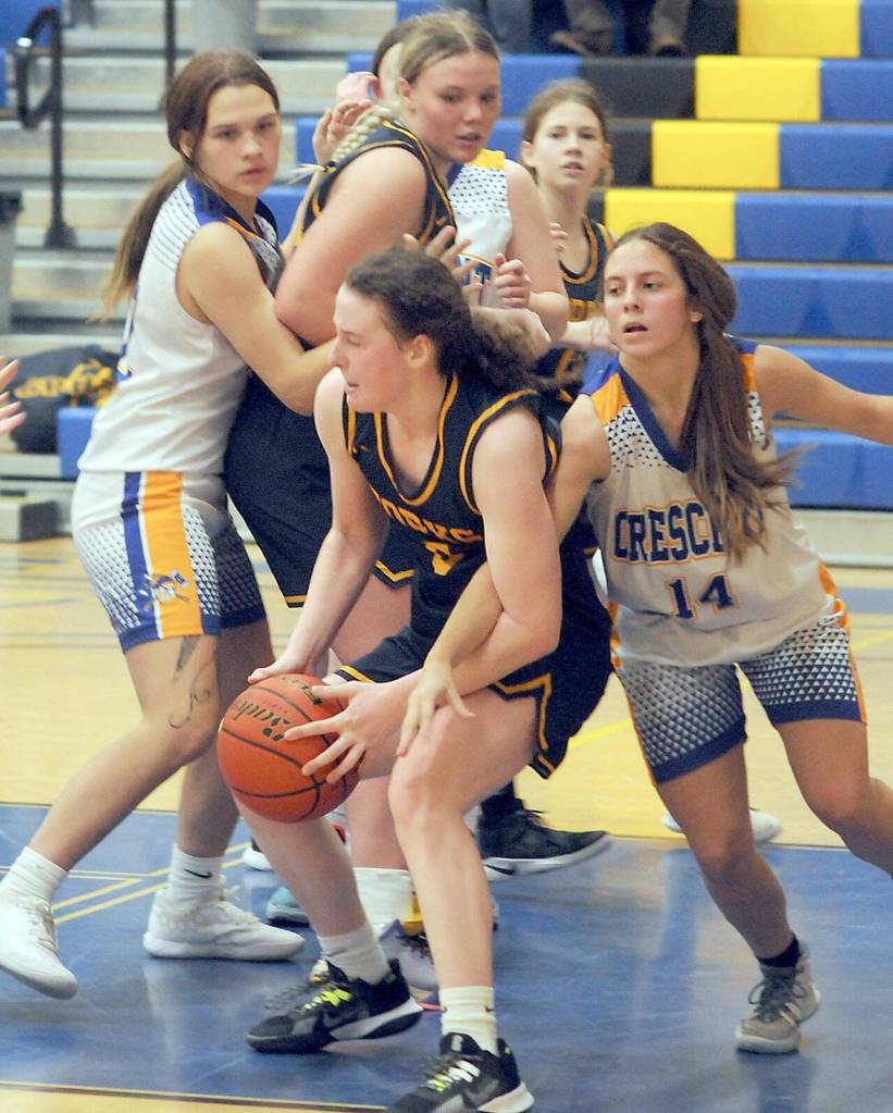 KEITH THORPE/PENINSULA DAILY NEWS
Forks's Keira Johnson looks tries to slip away from the pack as Crescent's Jocy Kazlanskas, right reaches in on Wednesday in Joyce. Looking on were, from left, Crescent's Chloe Ferro-May and Forks' Kyra Neel.