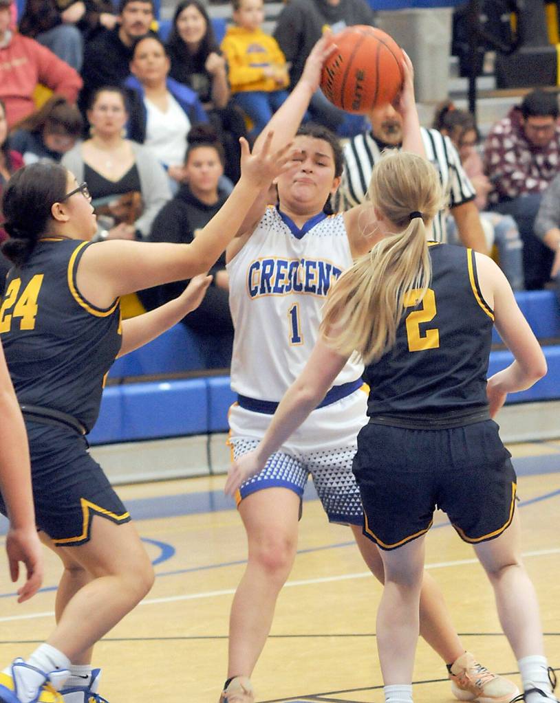 Crescents Ciara Cargo-Acosta, center, looks to pass while defended by Forks Janessa Ramos, left, and Kadie Wood on Wednesday in Joyce. (Keith Thorpe/Peninsula Daily News)