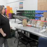 Emily Dexter, executive director of the Port Angeles Food Bank, looks over a collection of spices on Thursday that will be broken into smaller packages for distribution to the public. (KEITH THORPE/PENINSULA DAILY NEWS)