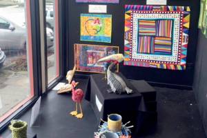 Among the pieces shown are, from left on the wall, quilts by Terri Wolf and Jeri Auty, both from Port Ludlow, and below, sculptures by Pat Herkal, with (foreground) ply-split vessels by Cathie Wier and 3-D constructions by Deb Olson, both from Port Townsend.