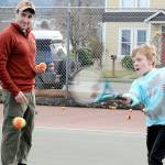 Noah Larsen, 9, of Port Angeles practices his forearm swing with the help from tennis instructor Jeff Gonzales on Thursday in Port Angeles. The pair worked with practice balls on the courts at Erickson Playfield. (Keith Thorpe/Peninsula Daily News)