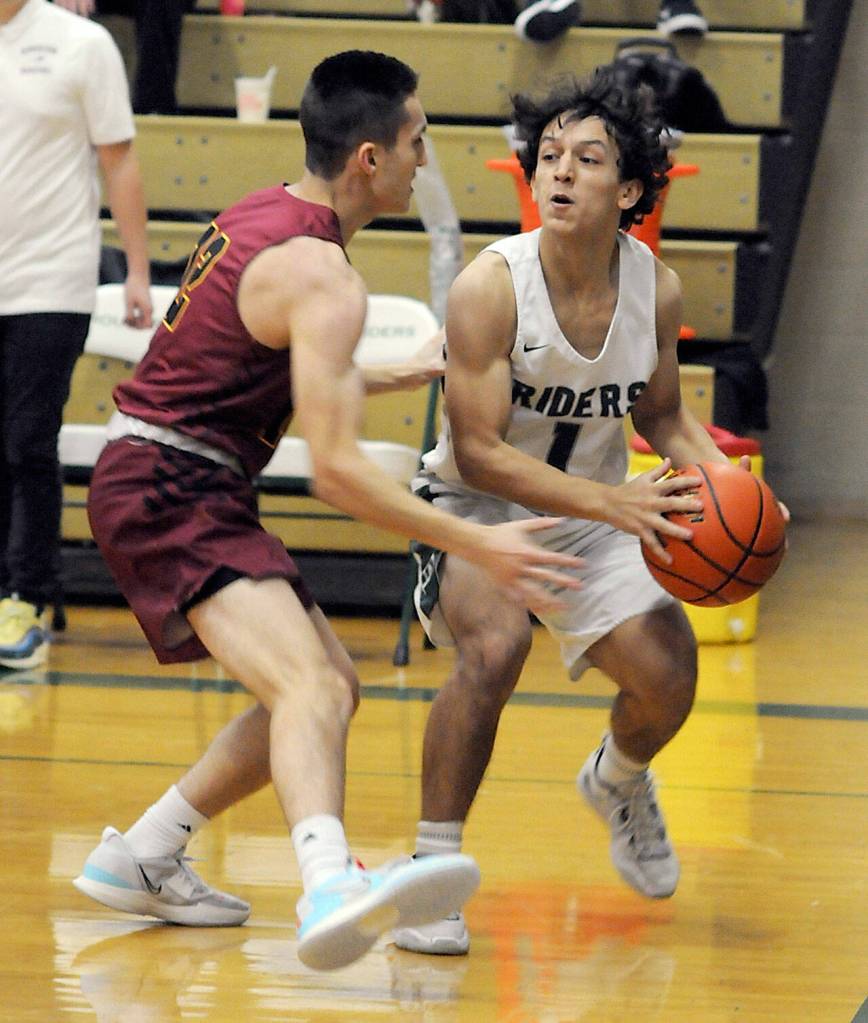 KEITH THORPE/PENINSULA DAILY NEWS Kason Albaugh of Port Angeles, right, looks for a way around Kingstons Louis Merlina on Thursday in Port Angeles.