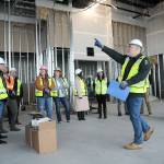Chris Fidler, project director of the Field Arts and Events Hall, points out features of the under-construction building during a tour with members of the Clallam County Economic Development Council on Friday.(KEITH THORPE/PENINSULA DAILY NEWS)