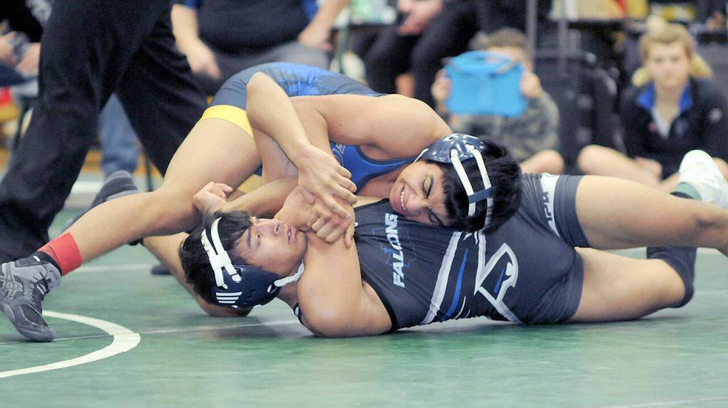 Bryan Lucas of Forks tries to pin Ravi Neumeyer of South Whidbey in the 120-pound class on Saturday at the Battle of the Axe in Port Angeles. (Keith Thorpe/Peninsula Daily News)