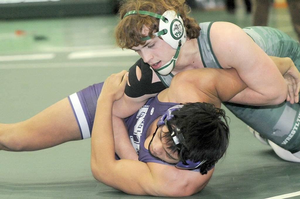 Trevor Collins of Port Angeles wrestles in the 182-pound class with North Thurstons Kymani Fejeran on Saturday in Port Angeles. (Keith Thorpe/Peninsula Daily News)