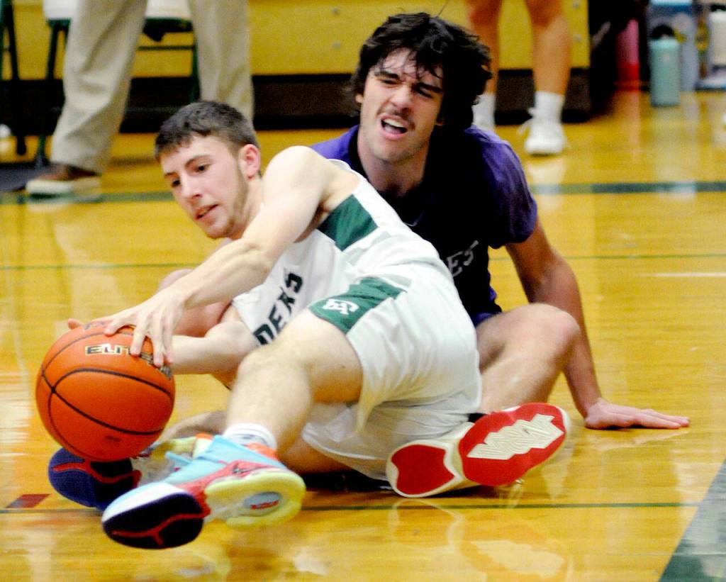 KEITH THORPE/PENINSULA DAILY NEWS
Port Angeles' Bryant Hoch, front, tangles on the floor over a loose ball with Sequim's Cole Smithson on Tuesday night in Port Angeles.