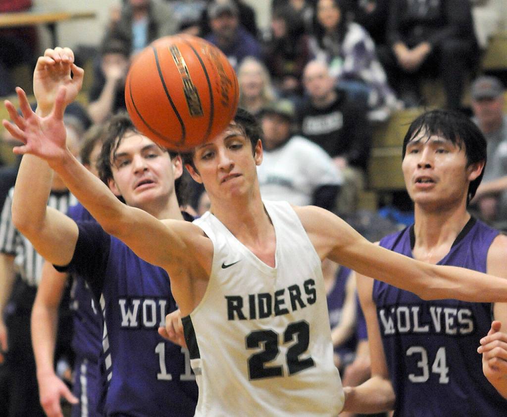 Port Angeles Tyler Hunter, center, watches a ball get away as Sequims Charlie Grider, left, and Isaiah Moore, right, look on during Tuesdays game in Port Angeles. (Keith Thorpe/Peninsula Daily News)