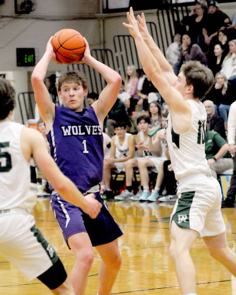 Sequims Zackary Thompson looks for a passing opportinity as Port Angeles Parker Nickerson, left, and Josiah Long close in on Tuesday at Port Angeles High School. (Keith Thorpe/Peninsula Daily News)