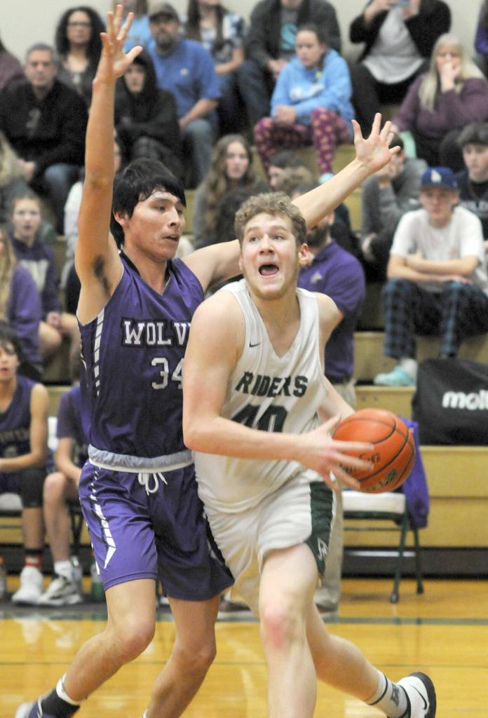 Port Angeles Isaiah Shamp, right, pushes past Sequims Isaiah Moore on the way to the lane on Tuesday night in Port Angeles. (Keith Thorpe/Peninsula Daily News)