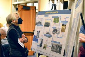 Margaret Groff of Port Townsend is among the scores of people perusing informational panels at Wednesdays open house. (Diane Urbani de la Paz/For Peninsula Daily News)