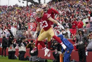 San Francisco 49ers running back Christian McCaffrey (23) is congratulated by wide receiver Jauan Jennings after scoring against the Seattle Seahawks during the first half of an NFL wild card playoff football game in Santa Clara, Calif., Saturday, Jan. 14, 2023. (AP Photo/Godofredo A. Vásquez)