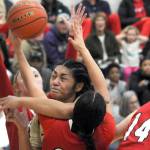 KEITH THORPE/PENINSULA DAILY NEWS
Peninsula's Ituau Tuisaula, center, bulls her way through the Skagit Valley defenders, from left, Kailyn Allison, Sarah Cook and Janae Rhoads on Wednesday night in Port Angeles.