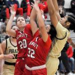 KEITH THORPE/PENINSULA DAILY NEWS
Peninsula's Ituau Tuisaula, right, reaches for a rebound over the heads of Skagit Valley's McKenna Wichers, left, and Sarah Cook as Pennsula's Ruth Moss looks on from behind on Wednesday night in Port Angeles.