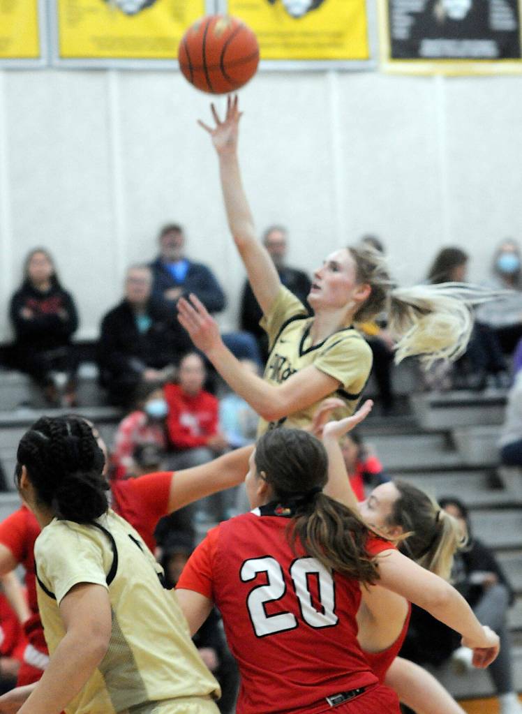 KEITH THORPE/PENINSULA DAILY NEWS
Peninsula's Millie Long, center, aims for the hoop on Wednesday night against Skagit Valley in Port Angeles.