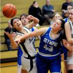 KEITH THORPE/PENINSULA DAILY NEWS Port Angeles Lindsay Smith, left, stretches for a rebound as Olympics Kylee Murphy reaches in on Thursday night in Port Angeles. Looking in at right is Lexie Smith of Port Angeles.