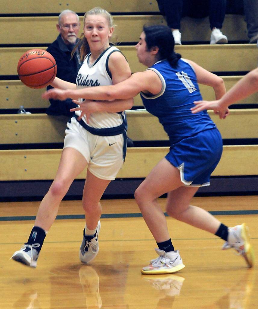 KEITH THORPE/PENINSULA DAILY NEWS Port Angeles Izzy Felton slips around the defense of Olympics Angelina Godinez-Gonzalez during Thursdays game at Port Angeles High School.