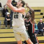 Keith Thorpe/Peninsula Daily News Port Angeles Isaiah Shamp, left, takes aim for the hoop as Rentons DeRai Taylor tries to defend on Saturday at Port Angeles High School.