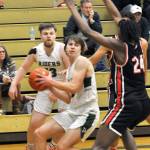 Keith Thorpe/Peninsula Daily News Port Angeles Parker Nickerson center, looks past the defense of Rentons Ajayi Simmons, right, as teammate Ezra Townsend looks on from behind during Saturdays game in Port Angeles.