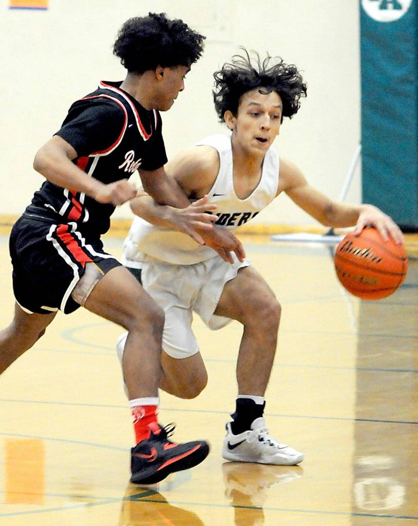 Keith Thorpe/Peninsula Daily News Port Angeles Kason Albaugh, right, advances the ball as Rentons Jordan Agosto tries to slow him down on Saturday in Port Angeles.