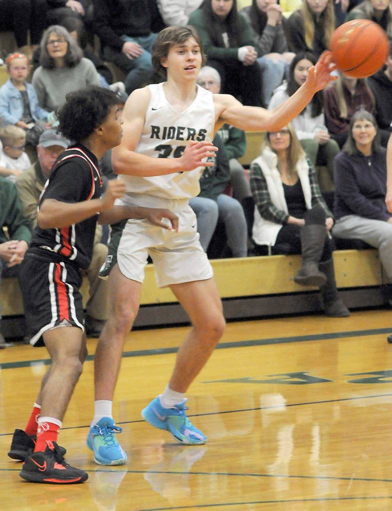 Keith Thorpe/Peninsula Daily News Port Angeles Parker Nickerson, right passes the ball as Rentons Jordan Agosto looks on during Saturdays game in Port Angeles.