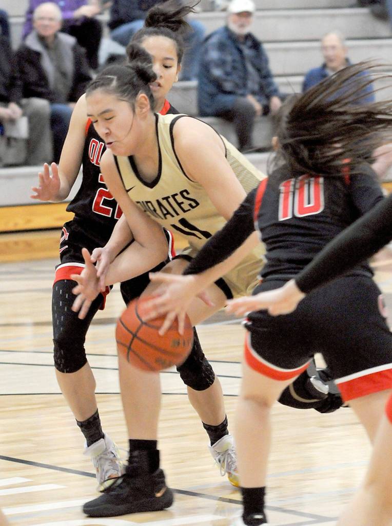 Peninsulas Jenilee Donovan tries to squeeze past Olympics Missy May Valdez, left, and Kylee Walker on Saturday at Peninsula College. (Keith Thorpe/Peninsula Daily News)