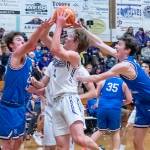 Sequim guard Zack Thompson, center, looks to score in a 64-44 Wolves win over North Mason on Tuesday. Thompson and Charlie Grider led Sequim in points with 16 each. (Emily Matthiessen/Olympic Peninsula News Group)