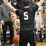 KEITH THORPE/PENINSULA DAILY NEWS
Port Angeles' Gus Halberg, left, waits for his chance at the basket as North Kitsap's Harry Davies, top, and Ethan Gillespie provide interference on Thursday at Port Angeles High School.