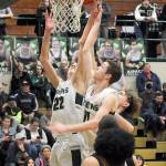 KEITH THORPE/PENINSULA DAILY NEWS Port Angeles Tyler Hunter, left, and teammate Dallas Dunning try to get the ball to the hoop as North Kitsaps Jaxon Korsak, left, tries to break up the play on Thursday night at Port Angeles High School.