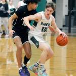 KEITH THORPE/PENINSULA DAILY NEWS Port Angeles Josiah Long, right, pushes off the defense of North Kitsaps Harry Davies during Thursdays game at Port Angeles High School.