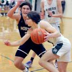 KEITH THORPE/PENINSULA DAILY NEWS Parker Nickerson of Port Angeles, front, drives to the lane as North Kitsaps Mason Chmielewski defends his territory while Nickersons teammate, Tyler Hunter, looks on from behind on Thursday night in Port Angeles.