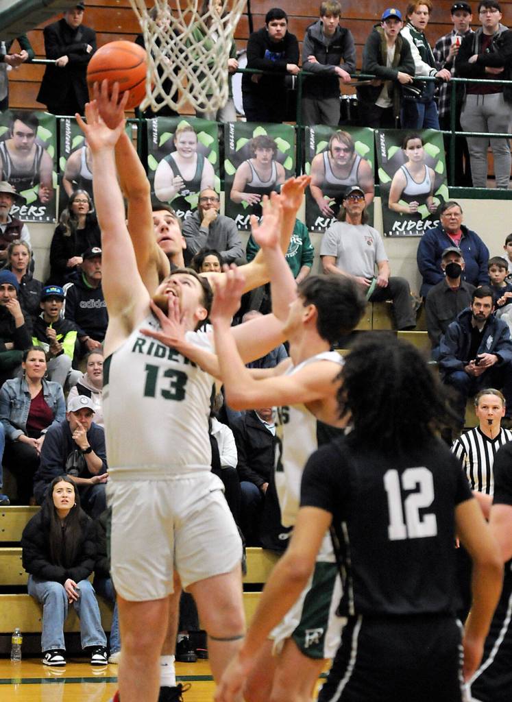 KEITH THORPE/PENINSULA DAILY NEWS Port Angeles Ezra Townsend, front, fights for a rebound with North Kitsaps Cade Orness as Townsends teammate, Tyler Hunter, center right, and North Kitsaps Harry Davies, front, look in on the play on Thursday night in Port Angeles.