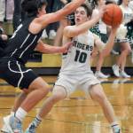 KEITH THORPE/PENINSULA DAILY NEWS Josiah Long of Port Angeles, right, looks for his teammates as North Kitsaps Mason Chmielewski blocks the way during Thursdays game in Port Angeles.