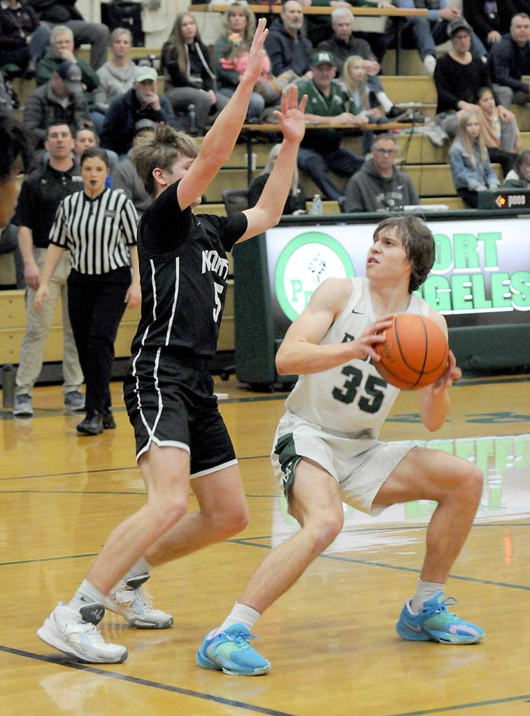 Keith Thorpe/Peninsula Daily News Port Angeles Parker Nickerson, right, looks for an opening around the defense of North Kitsaps Ethan Gillespie on Thursday night in Port Angeles.