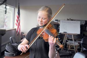Anabel Moore, 17, of Port Townsend warms up on the violin prior to performing for the judges during Saturdays 37th annual Nico Snel Young Artist Competition at Holy Trinity Lutheran Church in Port Angeles. Youth musicians from across the North Olympic Peninsula performed classical pieces for cash prizes in an event hosted by the Port Angeles Symphony Orchestra. (Keith Thorpe/Peninsula Daily News)